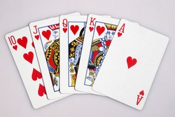 One of the highest hands in poker a heart Royal Flush isolated on white.