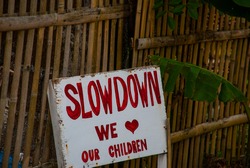 Sign at the fence Slowdown we love our children in the Philippines. Pandan, Panay island