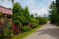 Rural road with houses in the Philippines. Pandan, Panay island