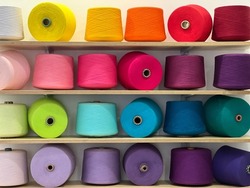 Spools of threads. Colorful bright cotton threads red, yellow, orange, blue, green, purple, violet, lilac, pink, pale pink, magenta, crimson, white, turquoise, carmine, lavender, burgundy colors.