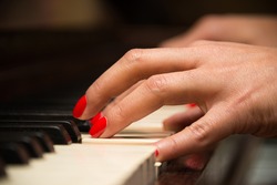 Female pianist hands closeup and piano keyboard