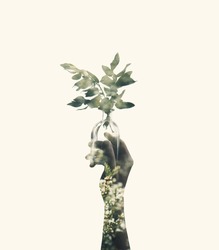 Double exposure with hand holding glass jar with branch plant