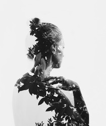 Creative double exposure portrait of attractive girl with branches of tree