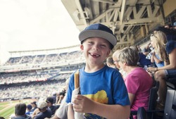 Young boy enjoying a day watching a professional baseball game
