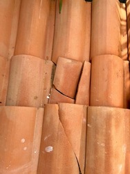 Clay tile terracotta or terracotta-clay tiles roof. Gable roof close up on tropical home.