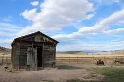 Outlaw Butch Cassidy's barn. Old barn with beautiful field and sky background. 