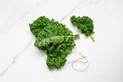 Top view of bunch green fresh kale on light surface