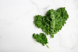 Top view of bunch green fresh kale on light surface copy space