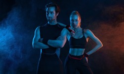 Sprinter run. Strong athletic woman and man running on black background wearing in the sportswear. Fitness and sport motivation. Runner concept.