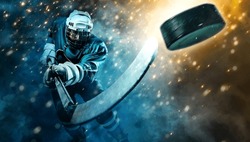 Ice Hockey player athlete in the helmet and gloves on stadium with stick. Action shot. Sport concept.  Sports betting. Bets in the mobile application.