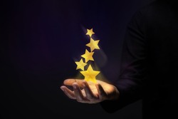 Success in Business or Personal Talent Concept. Gesture Hand with Golden Five Star Awards