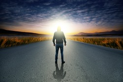 man in  road at sunset