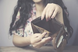 Empty brown wallet in woman hands