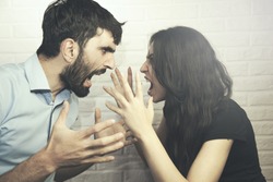 attractive angry couple fighting and shouting at each other