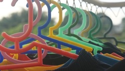 Colorful coat hanger hanging on the rack.