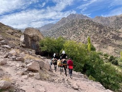 Toubkal National Park, Morocco, 25.10.2021. Locals on mules in the High Atlas Mountains on the way to Sidi Chamharouch, a pre-islamic marabou shrine.