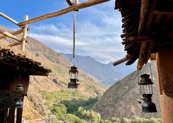 View of Toubkal National Park from a beautifully decorated rooftop terrace at a Berber homestay in the High Atlas Mountains. Imlil valley, Morocco.
