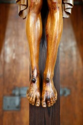 St. James the Apostle church.  Jesus Christ statue. The crucifixion.  Close-up on feet.  Italy. 