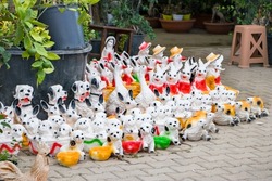Animal figurines on the ground. A couple of black-white puppy , dog, gazelle, goose, turtle statue.Selective Focus.