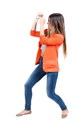 skinny woman funny fights waving his arms and legs. Isolated over white background. The girl in the red jacket standing in a boxing pose protecting her face from the blow.