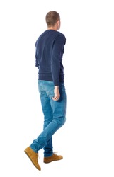 Back view of going  handsome man. walking young guy . Rear view people collection.  backside view of person.  Isolated over white background. A guy in a black sweater goes sideways.