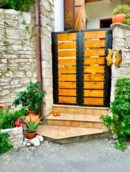 Tourist view. View of a wooden door in the tourist Cypriot mountain village of Lanja. The craft of making wooden shoes.