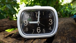 Modern small black alarm clock object photography