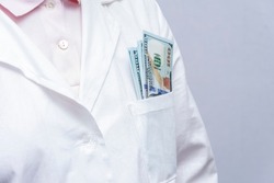There's a wad of money in the doctor's pocket. Concept: a bribe to an official, the attending doctor, the diy of medical documents and tests.