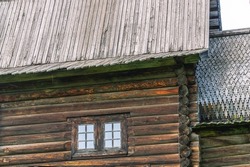 A wooden structure made of huge logs. Cracked dark logs of a wooden house. A large old wooden building built in the 17th century.