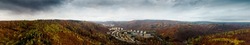 Panoramatic Highres aerial drone view on city Adamov surrounded by colorful autumn forest