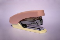 An old light brown stapler which is still in good condition but is starting to rust.