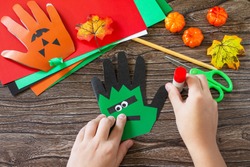 Instructions, step 12. Greeting card halloween on wooden table. Children's creativity project, crafts, crafts for kids.