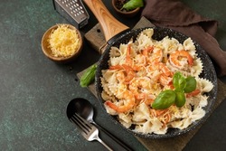 Mediterranean cuisine, seafood diet, italian cuisine. Pasta farfalle with grilled shrimps bechamel sauce. Farfalle with seafood rich cream. Copy space.