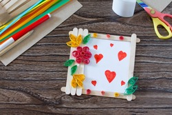 Children's gift from wooden sticks photo frame, birthday greeting card. Copy space. Handmade. Project of children's creativity, handicrafts, crafts for children.