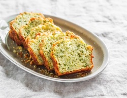 Savory zucchini, herbs, cheese snack cake on a light background, top view             