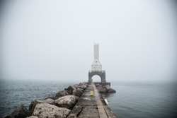 Lighthouse Through Fog Along Pier