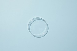 Petri dish with water and different ripple on blue background