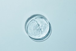 Petri dish with water and different ripple on blue background