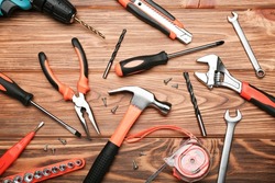 Set of various construction tools on a wooden background. Tools for home repair. Work at a construction site. Top view