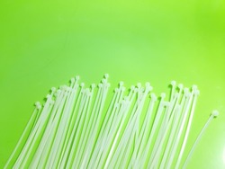 nylon cable ties measuring 2.5 x 200 millimeters in white, in the photo above isolated green background