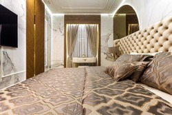 luxury hotel bedroom. Bed with carriage coupler headboard