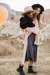 mother and daughter. mom and baby. mother and baby girl watching air balloons. mother with daughter travel. travel family. happy family. 