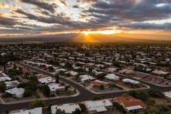 Scenic view of Green Valley Arizona during sunrise with sun rays and clouds. 