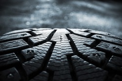 Winter tires photographed in close-up view in Finland. Focus point is in the center of the numbers. The front and back out of focus. Image includes a heavy effect.