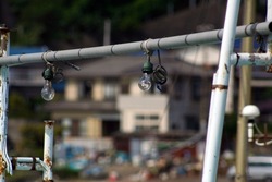 Close up photography of a night fishing light bulb set on a Japanese fishing vessel, settled in the base port.
