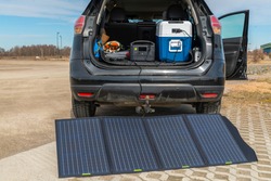 Off-grid camping equipment, which consists of a collapsible solar panel, power generator and a compressor cooler

