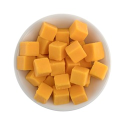 Top view of cubed mild cheddar cheese in a small bowl isolated on a white background.