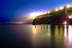 Golden Gate Bridge illuminated at night from Horseshoe Bay in Sausalito, California, United States. The Golden Gate is a symbol of San Francisco, californian landmark. Long exposure shot.