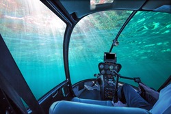 Underwater submarine ship cockpit in the blue ocean with sunbeams and copy space. Undersea background. Travel concept.