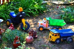 old toy trucks in the yard of a house